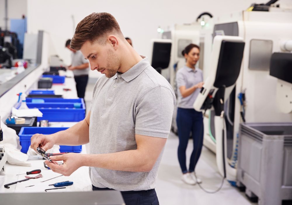 Male Engineer Quality Controlling Components In Factory